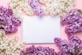Lilac and notepad on pink background. Still life. Spring romantic mood. Top view. Copy space Royalty Free Stock Photo