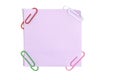 Lilac paper sticker for written notes and paper clips on a white background Royalty Free Stock Photo