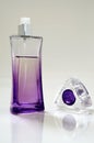 Lilac perfume bottle and cap removed Royalty Free Stock Photo