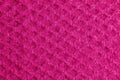 Lilac-pink knitted carpet close-up. Textile texture on a lilac-pink background. Detailed warm yarn background. Natural wool fabric Royalty Free Stock Photo