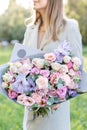 Lilac and pink pastel beautiful spring bouquet. Young girl holding a flower arrangement with various flowers. Bright Royalty Free Stock Photo