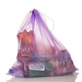 Lilac polyethylene bag with garbage isolated on white.