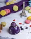 Lilac round cake with macarons on a white wooden board Royalty Free Stock Photo