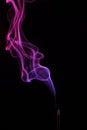 Lilac smoke incense sticks on a black background Royalty Free Stock Photo