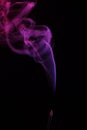 Lilac smoke incense sticks on a black background Royalty Free Stock Photo