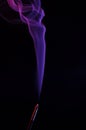 Lilac smoke incense sticks on a black background Royalty Free Stock Photo