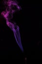 Lilac smoke incense sticks on a black background Royalty Free Stock Photo