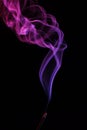 Lilac smoke incense sticks on a black background Royalty Free Stock Photo