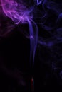 Lilac smoke incense sticks on a black background Royalty Free Stock Photo