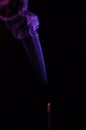 Lilac smoke incense sticks on a black background Royalty Free Stock Photo