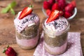 Lilac smoothie with strawberry, baÃâanas and chia pudding in two jars on wooden background