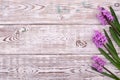 Lilac spring flowers border on wooden rustic table, above view Royalty Free Stock Photo