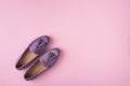 Lilac suede moccasins shoes over lilac pink background