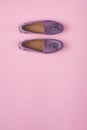 Lilac suede moccasins shoes over lilac pink background