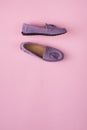 Lilac suede moccasins shoes over lilac pink background