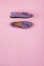 Lilac suede moccasins shoes over lilac pink background