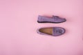 Lilac suede moccasins shoes over lilac pink background