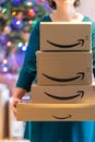 Lille, France - December 18, 2020 : Amazon packages deposited at the foot of the Christmas tree Royalty Free Stock Photo