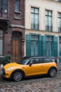 Profile view of orange mini cooper parked in the street