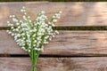 Lilly of the valley flowers on wooden background. Royalty Free Stock Photo