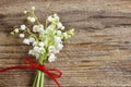 Lilly of the valley flowers on wooden background.