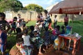 LILONGWE, MALAWI, AFRICA - APRIL 2, 2018: Bright road scene, african women and children are sitting along the roads, smiling and