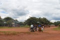 LILONGWE, MALAWI, AFRICA - APRIL 1, 2018: Men in suits is speaking with African woman with child near the road in one of the