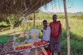 LILONGWE, MALAWI, AFRICA - MARCH 25, 2018: African boys are selling potatos, tomatoes, cabbage and oil under wooden natural roof.
