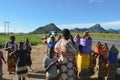 LILONGWE, MALAWI, AFRICA - MARCH 25, 2018: African women and children are smiling and selling potatos along the road to Dedza.