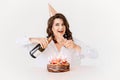 a lilt woman with champagne and a birthday cake with candles. Royalty Free Stock Photo