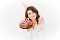 a lilt woman with a glass of champagne and a birthday cake with candles. Royalty Free Stock Photo
