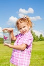 Lilttle girl holds jar with buterfly