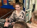 Lily James signing autuographs outside The Noel Coward Theatre following her performance in All About Eve.