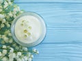 Lily of the valley flower moisturizer cosmetic cream relaxation on blue wooden Royalty Free Stock Photo