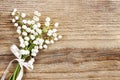 Lily of the valley flowers on wooden background. Royalty Free Stock Photo