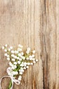 Lily of the valley flowers on wooden background. Royalty Free Stock Photo