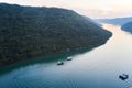 Lim Channel at sunset with boats serving oyster farms. Shot from a drone.