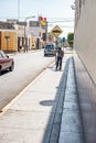 LIMA, PERU - APRIL 12, 2013: Street and boy going with skateboard on sidewalk