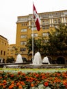 Lima Peru. The flag of Peru in white and red colors, in a fountain and in the background a yellow building.