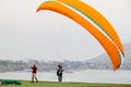 LIMA, PERU - JUNE 4, 2015: Paraglider gets ready to fly over cliffs of Miraflores district of Li