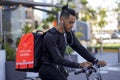 Good looking man in bike working for Rappi food delivery service