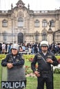 Police officers watch over a procession in Lima, Peru