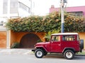 Red and white Toyota Land Cruiser parked in Lima