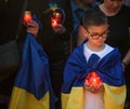 Boy with a candle and flag of Ukraine during an event in memory of the Ukrainian victims killed in Bucha Royalty Free Stock Photo
