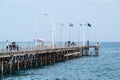 Limassol, Cyprus - Diagonal view over the wooden pier at the old harbour with Greek, Cypriot and European flags