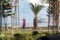 Limassol, Cyprus - February 22, 2019: People Walking at Molos Seaside Park with Offshore Drilling Rig on background