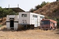 Limassol, Cyprus - June 2020: Abandoned horse wagons and fire track in desert landscape of a farm