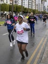 Smiling black woman running in Limassol Marathon Corporate race, Cyprus Royalty Free Stock Photo