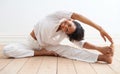 Limber and invigorated. A pretty young woman doing stretches before a workout.