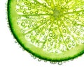 Lime with bubbles in water isolated on white background Royalty Free Stock Photo